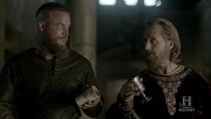 Ragnar (Travis Fimmel) and King Ecbert (Linus Roache) do not approve of drinking poisoned wine in Episode 4 (entitled Scarred) Season 5 of History Channel's Vikings